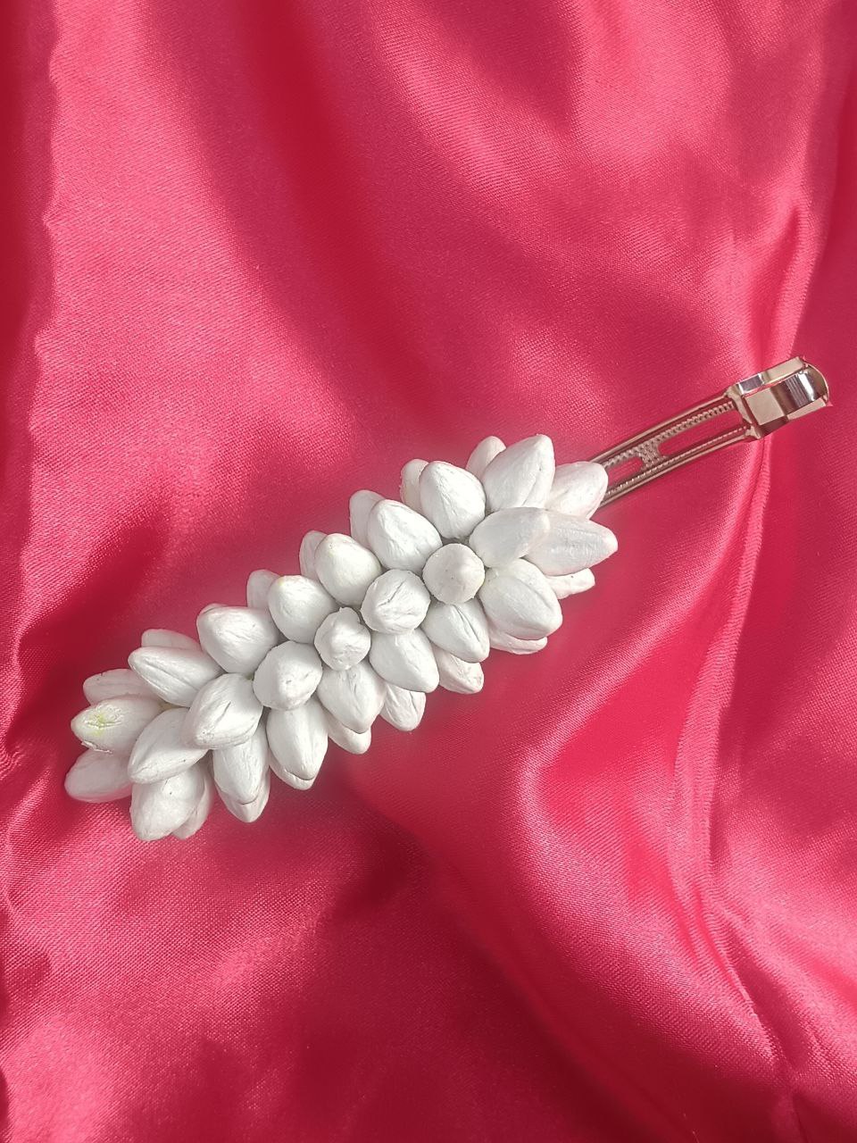Artificial Jasmine Buds Hair Clip in White Artificial jasmine buds white floral hair clip with metal barrette on pink background
