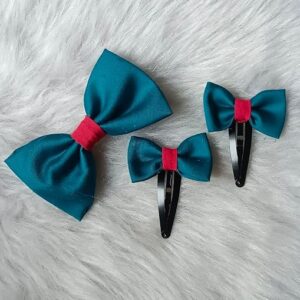 Cloth bow hair clip set with red center band including 1 alligator clip and 2 tic tac clips placed on a soft fluffy background.