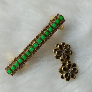 Gold-tone green stone barrette hair clip with matching floral saree pin on soft background