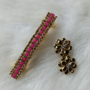 Gold-tone floral stud earrings featuring pink square-cut stones arranged in a flower design on a soft white background