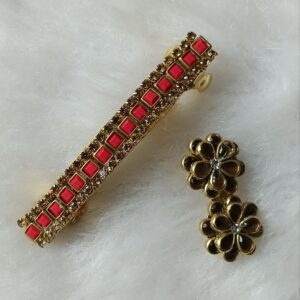 Gold-tone red stone barrette hair clip with matching floral saree pin on soft background