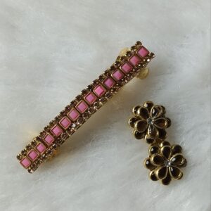 Gold-tone pink stone barrette hair clip with matching floral saree pin on soft background