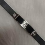 Stylish black strap bracelet with metallic centerpiece for men